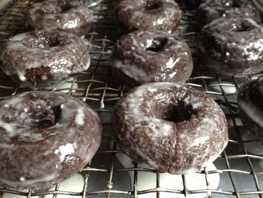 Baked gluten free chocolate doughnut on cooling rack.