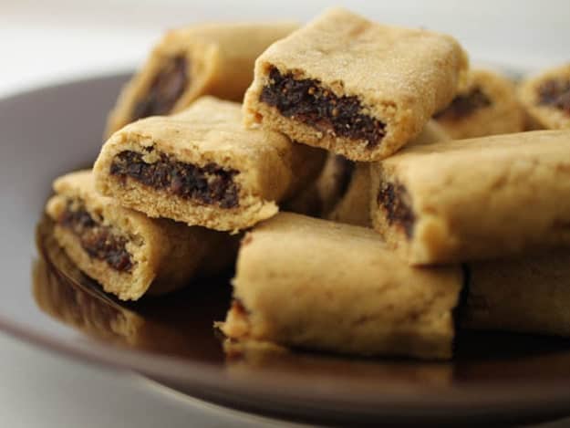 Gluten-free fig newton cookies on a brown plate.