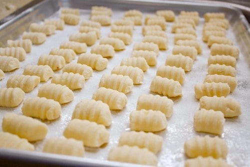 Gluten-free gnocchi on a baking pan.