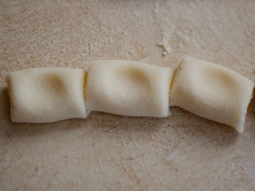 Gluten-free gnocchi dough cut into pieces.