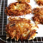 Gluten-free latkes on a wire rack.