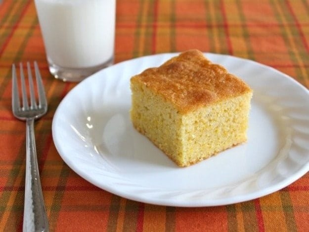 Slice of gluten-free cornbread on a white plate.