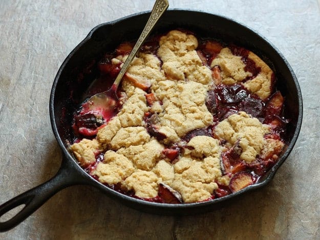 Gluten-Free Plum Cobbler in a cast iron skillet.