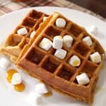 Sweet Potato Casserole Waffles with mini marshmallows and syrup on a plate.