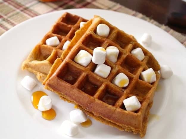 Sweet Potato Casserole Waffles with mini marshmallows and syrup on a plate.