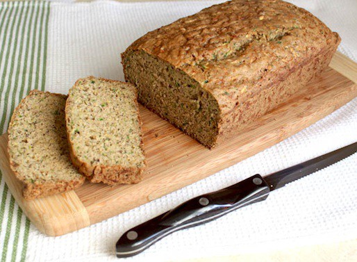 Gluten-Free Zucchini Bread sliced on a wood cutting board.