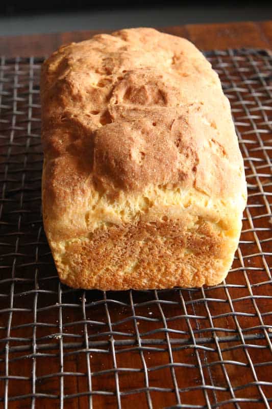 Gluten-free sandwich bread cooling on a wire rack.