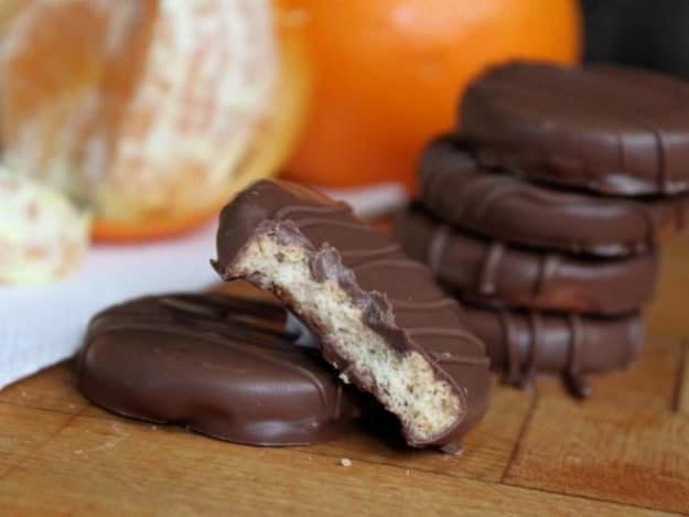 No Bake Chocolate-Dipped Orange Cookies in a stack. One cookie has a bite taken from it.