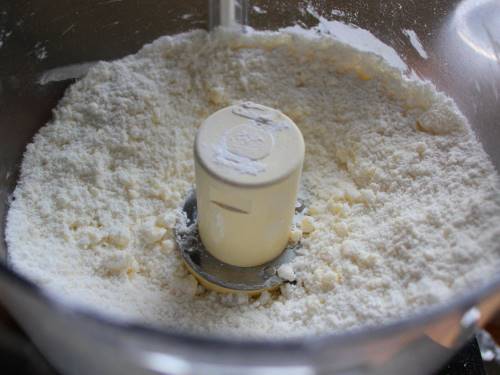 Gluten-free flour and butter mixture in the bowl of a food processor.