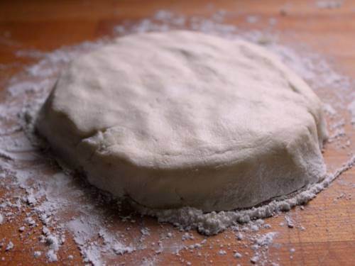Gluten-free pie dough on wood counter.
