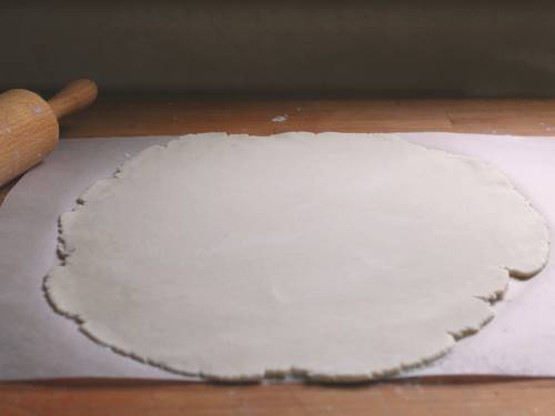 Gluten-free pie dough rolled out into a round.