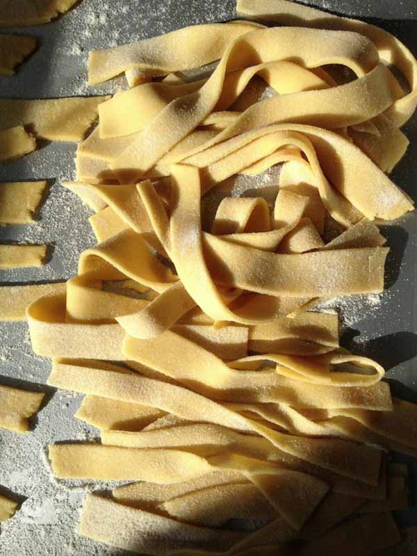 Fresh gluten-free pasta on sheet pan.