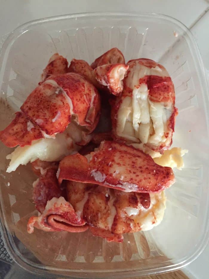 Lobster meat in small plastic container.