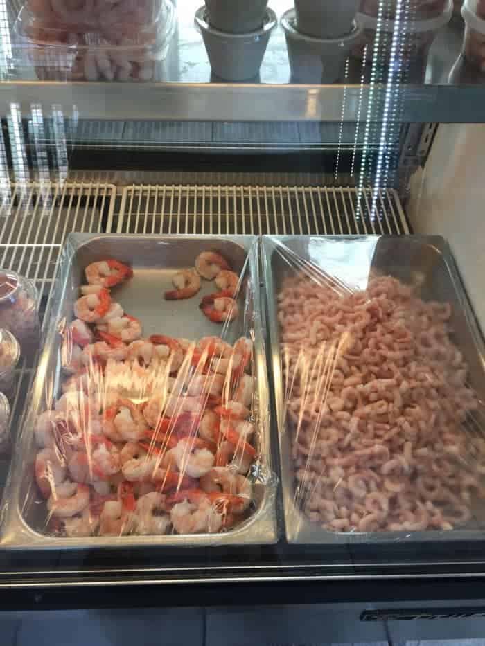 Deli pans of shrimp and tiny shrimp.