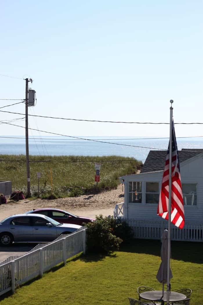 American flag on pole. Ocean in the distance.