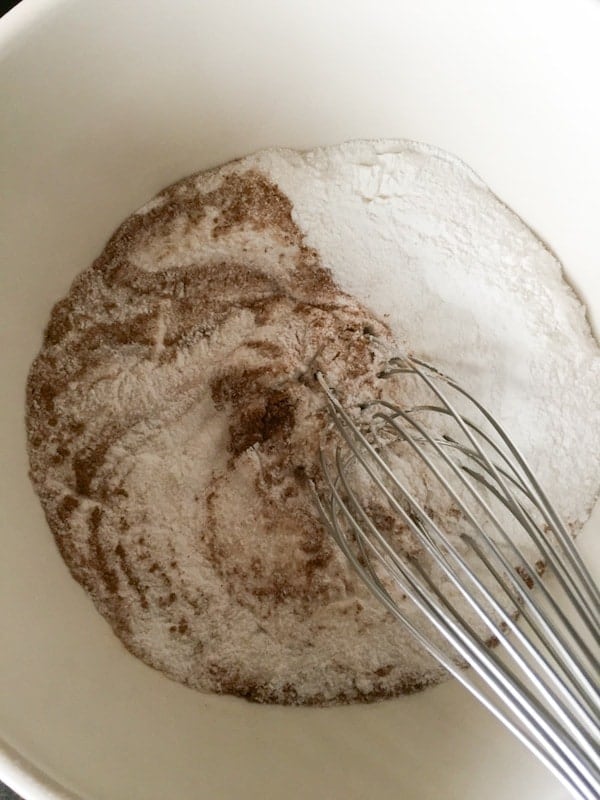 Whisking dry ingredients for gluten-free pumpkin spice cake.