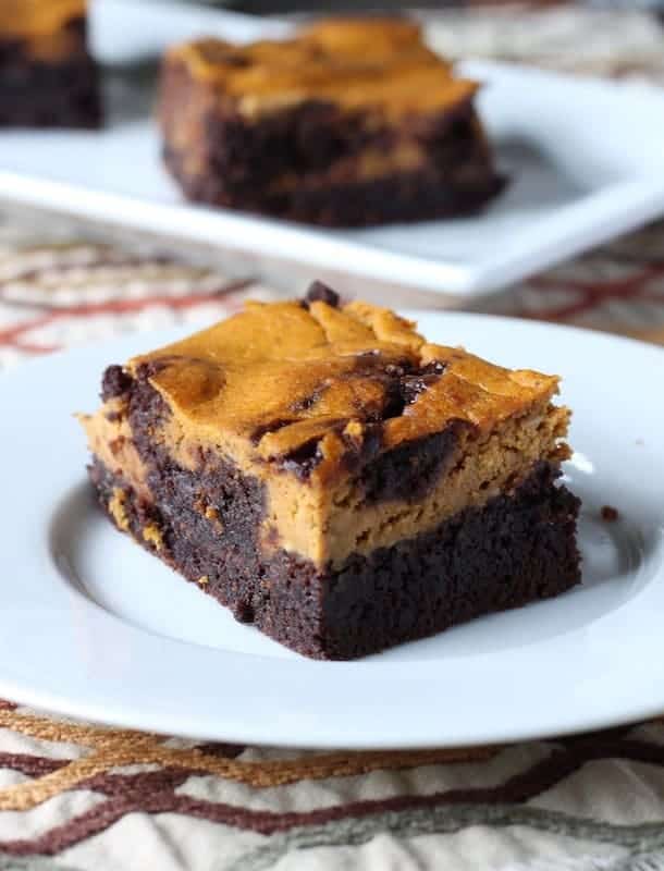 Pumpkin Cheesecake Brownies on a white plate.