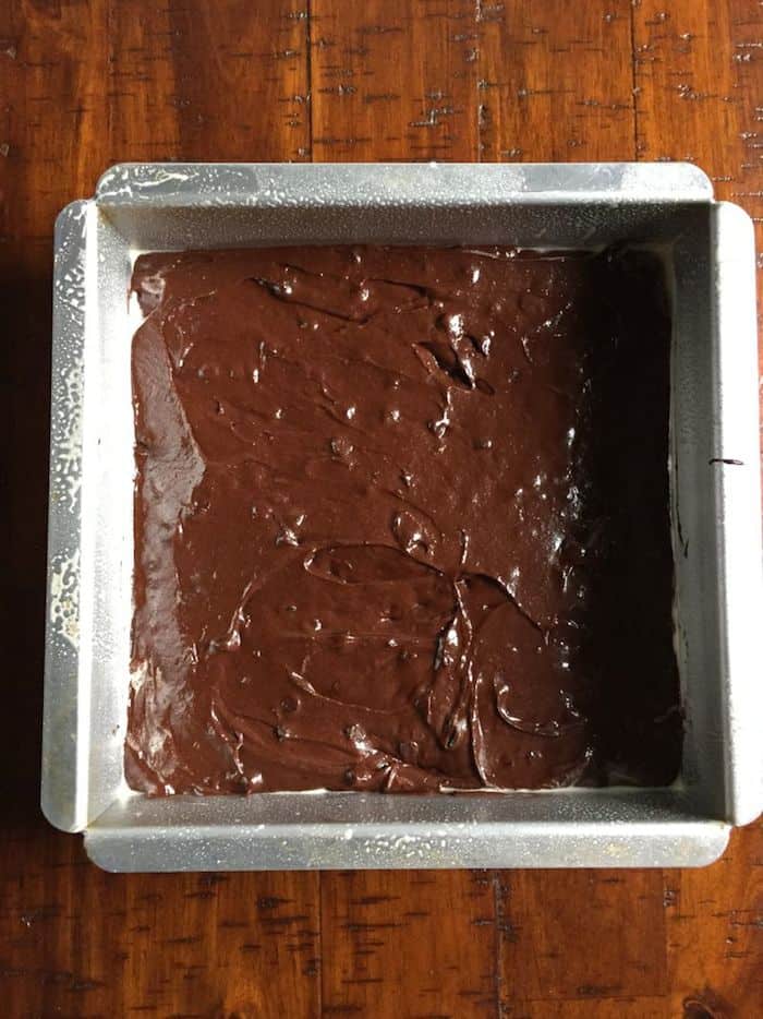 Gluten-free brownie batter spread in pan.