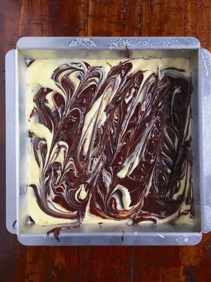 Gluten-free cheesecake brownie batter in pan.