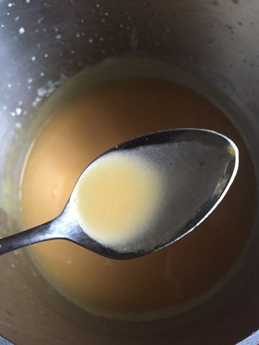 Gluten-free gravy on a spoon.