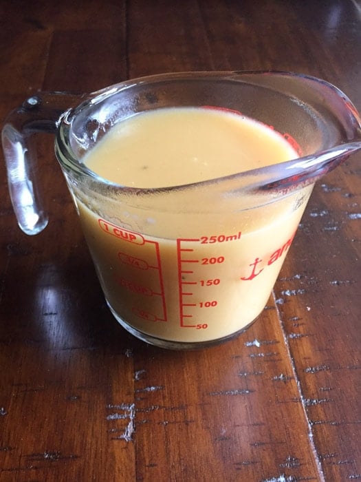 Gluten-free gravy in a measuring cup.