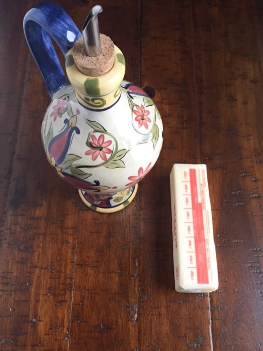 Ceramic live oil container and a stick of butter.