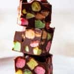 Stack of chocolate marshmallow bar with colorful fruity marshmallows.