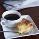 Gluten-free bisquick coffee cake next to a cup of coffee.