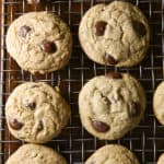 Gluten-free chocolate chip cookies cooling on a wire rack.