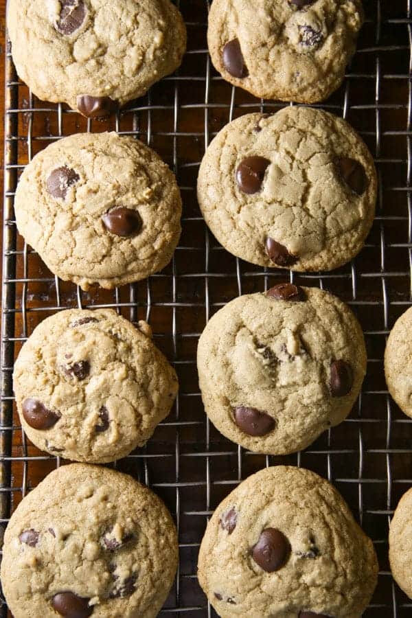 Gluten-free chocolate chip cookies cooling on a wire rack.