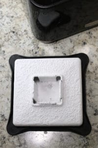 Corn-free powdered sugar coats a blender lid.