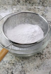Sifting corn-free powdered sugar.