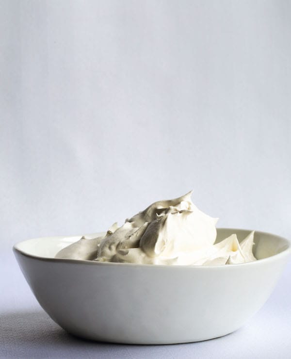 Whipped coconut cream in a ceramic bowl.