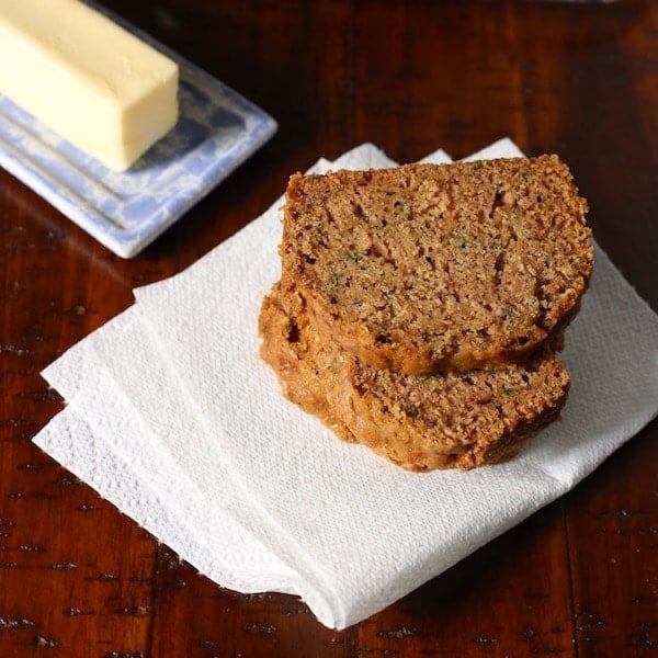 Two slices of zucchini bread on paper napkin.