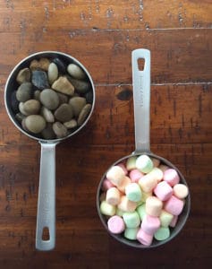 Measuring cup filled with stones (left). Measuring cup filled with colorful marshmallows. (Right)