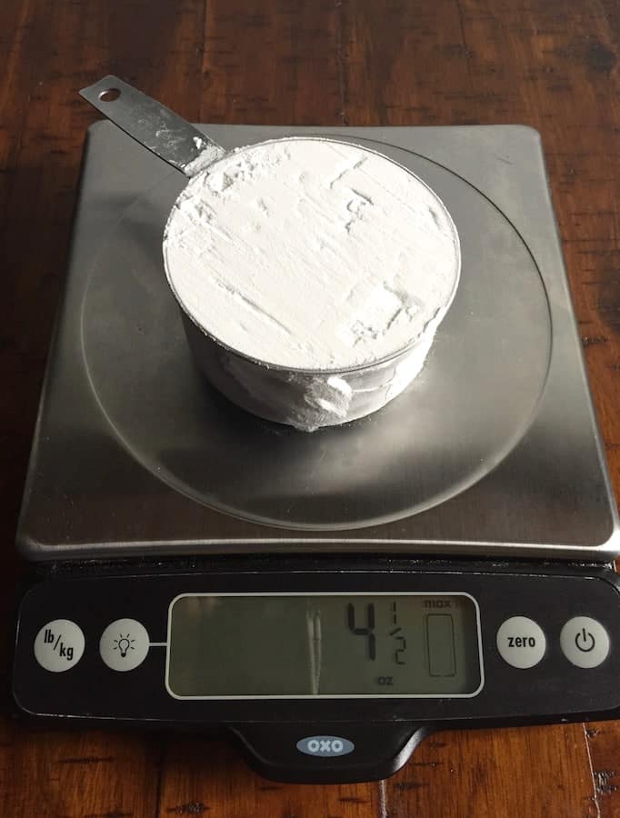 Cup of tapioca starch on a digital scale. Display reads 4 1/2 ounces.