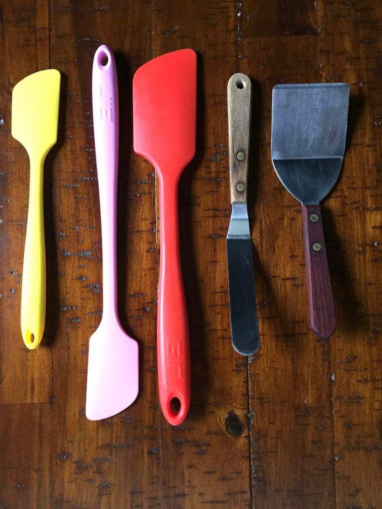 Different types of spatulas. Three rubber spatulas. One angled spatula. One cookie spatula.