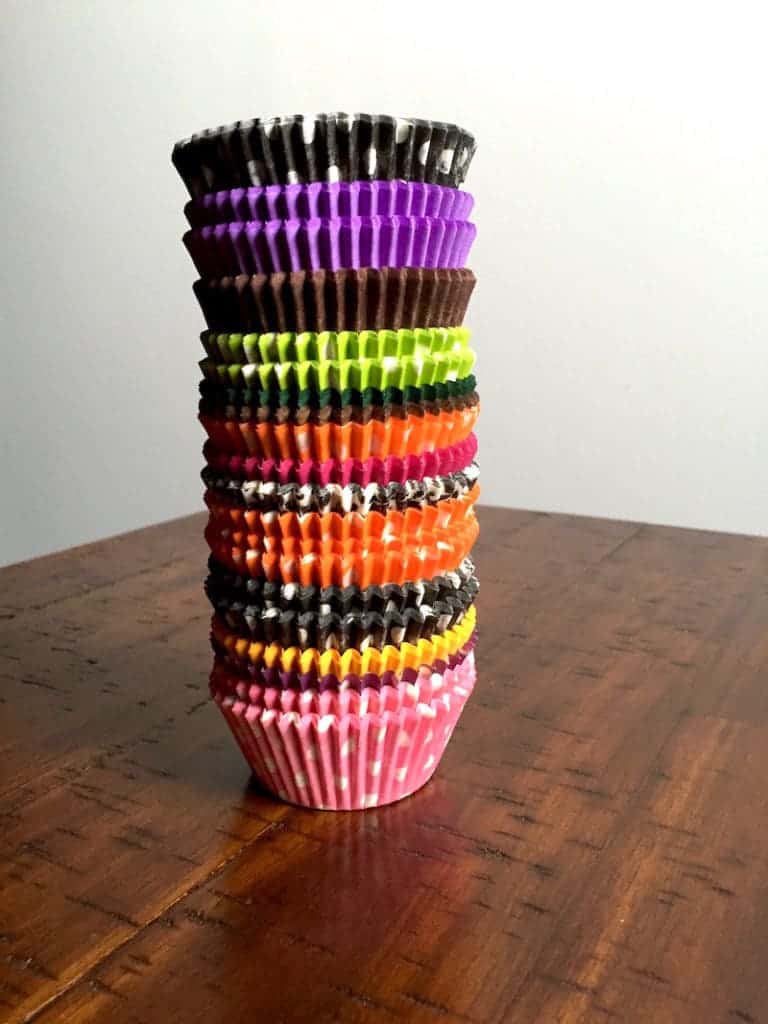 Stack of colorful paper muffin cups.