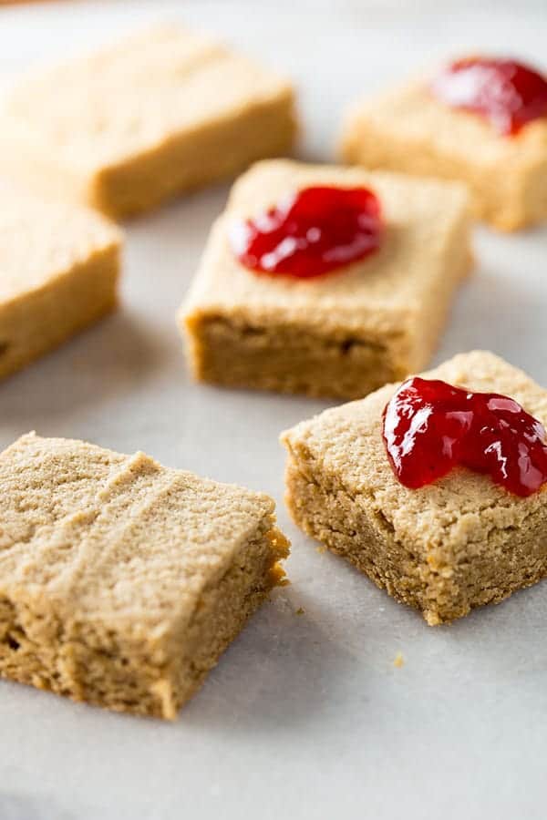 Gluten-free peanut butter blondies with jam on top.