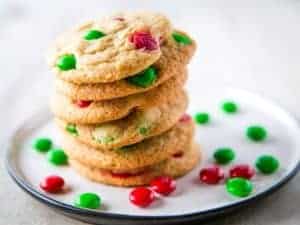 Gluten-free M&Ms cookies with red and green M&Ms on a plate.