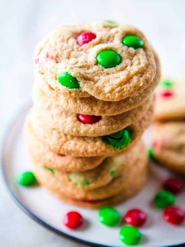 Gluten-free M&Ms cookies with red and green M&Ms on a plate.