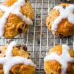 Baked Gluten-Free Hot Cross Buns on a Wire Rack.