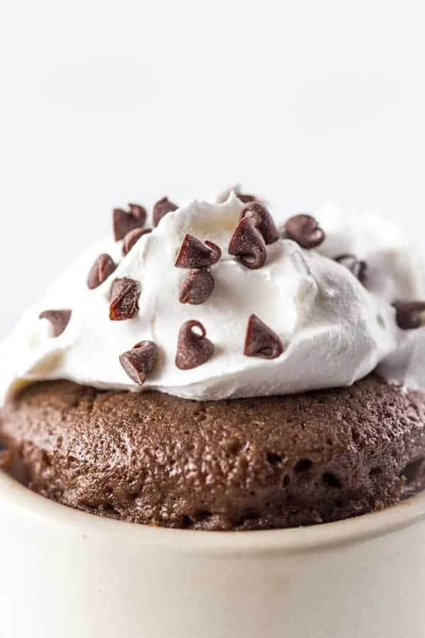 Gluten-Free Chocolate Mug Cake Closeup. Topped with Whipped Cream and Mini-Chocolate Chips