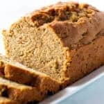Loaf of sliced gluten-free zucchini bread on a white platter.