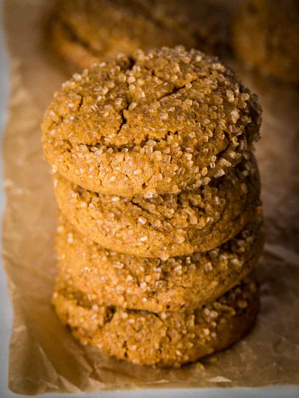 Gluten-free molasses cookies, with coarse sugar, in a stack.