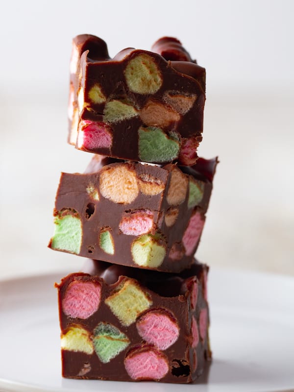 Stack of three chocolate marshmallow bars with colorful fruit marshmallows.