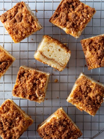 Squares of baked gluten-free coffee cake on a wire rack