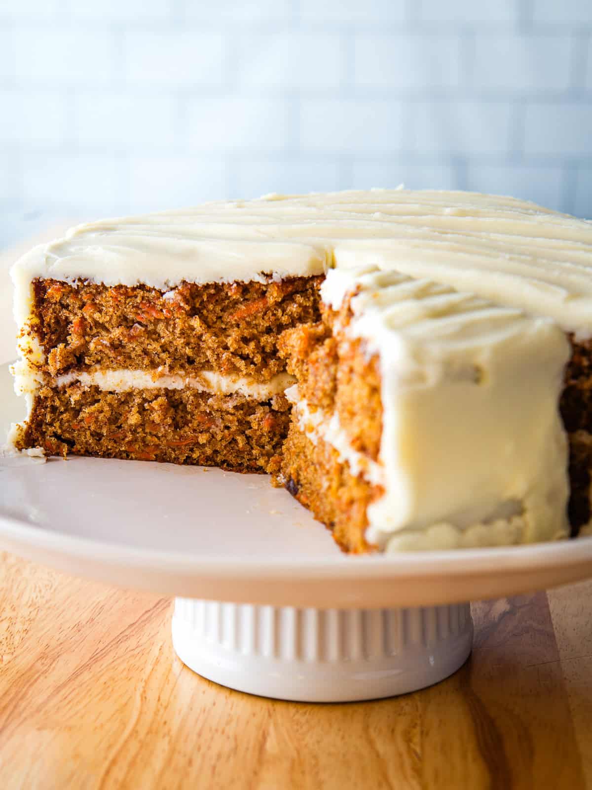 Gluten-free carrot cake on a cake stand.