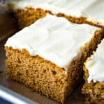 Gluten-free spice cake in pan with cream cheese frosting.