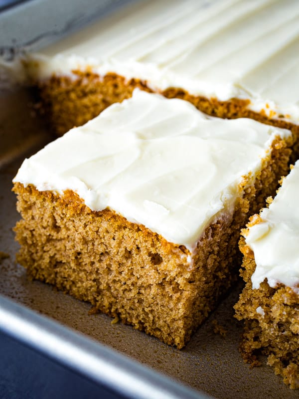 Gluten-free spice cake in pan with cream cheese frosting.
